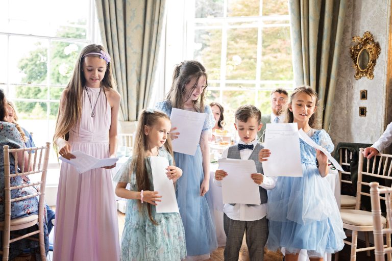 Children reading a poem about the wedding. in a Georgian dining room.