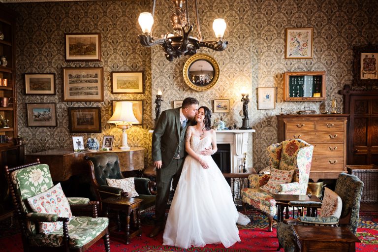 Georgian styled living room (old furniture and picture frames) with a bride and groom centre place in front of a beautiful fireplace.
