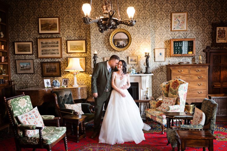 Georgian styled living room (old furniture and picture frames) with a bride and groom centre place in front of a beautiful fireplace.
