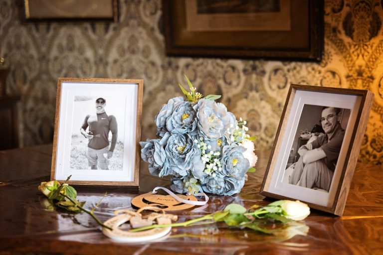 Two frames of lost loved ones. Wedding bouquet centered in between the frames